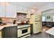 Kitchen featuring retro yellow appliances, updated countertops, and convenient access to the living room at 6187 Crittenden Ave, Indianapolis, IN 46220