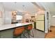 Well-lit kitchen featuring white cabinets, a center island with seating, and unique yellow appliances at 6187 Crittenden Ave, Indianapolis, IN 46220