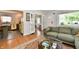 Open floor plan featuring living room with hardwood floors and connecting kitchen with vintage appliances at 6187 Crittenden Ave, Indianapolis, IN 46220