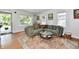 Bright living room featuring hardwood floors, corner sofa, and large windows at 6187 Crittenden Ave, Indianapolis, IN 46220