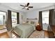 Serene main bedroom featuring a comfortable bed, hardwood floors, and natural light at 6187 Crittenden Ave, Indianapolis, IN 46220