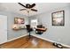 Functional office showcasing a ceiling fan, modern desk, hardwood floors, and media at 6187 Crittenden Ave, Indianapolis, IN 46220