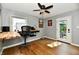 Charming office space with a ceiling fan, custom wood desk, hardwood floors, and natural light at 6187 Crittenden Ave, Indianapolis, IN 46220