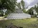 View of an under-construction home featuring a lush green yard and mature trees at 6326 N Main St, Wilkinson, IN 46186