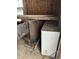A close-up of an aged furnace and weathered white cabinet inside an unfinished home at 6326 N Main St, Wilkinson, IN 46186