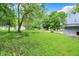 Spacious backyard featuring mature trees, a well-manicured lawn, and a private setting at 6430 E Southport Rd, Indianapolis, IN 46237