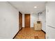 The room has unfinished brick wall, and door leading to another space at 6430 E Southport Rd, Indianapolis, IN 46237