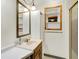 Bathroom with vanity, a large mirror, and a glass-enclosed shower at 6430 E Southport Rd, Indianapolis, IN 46237