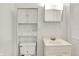 Bathroom with white vanity, toilet, and medicine cabinet for a clean and simple design at 6430 E Southport Rd, Indianapolis, IN 46237