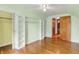Bedroom with wood floor, shelving, and a ceiling fan at 6430 E Southport Rd, Indianapolis, IN 46237