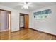 Bright bedroom with hardwood floors, closet, and sunlit window offers a cozy retreat at 6430 E Southport Rd, Indianapolis, IN 46237