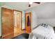 Bedroom featuring wood floors and closet space at 6430 E Southport Rd, Indianapolis, IN 46237