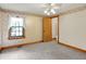 Cozy bedroom features natural light from the window and a convenient attached bathroom at 6430 E Southport Rd, Indianapolis, IN 46237