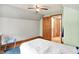 Bedroom featuring wood floors, a ceiling fan, and blue carpet at 6430 E Southport Rd, Indianapolis, IN 46237