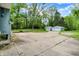 Long driveway leading to two garages and a house with an ample parking area at 6430 E Southport Rd, Indianapolis, IN 46237