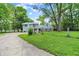 Charming two-story home with a well-maintained lawn, fenced yard, and mature trees at 6430 E Southport Rd, Indianapolis, IN 46237
