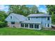 Charming home exterior featuring light blue siding, stone accents and lots of bright windows at 6430 E Southport Rd, Indianapolis, IN 46237
