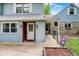Charming front entrance with a covered porch, blue siding, and well-maintained landscaping at 6430 E Southport Rd, Indianapolis, IN 46237