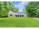 Beautiful home exterior with green lawn and long driveway at 6430 E Southport Rd, Indianapolis, IN 46237