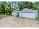 Detached two-car garages with white doors and concrete driveway at 6430 E Southport Rd, Indianapolis, IN 46237