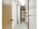 Hallway featuring vinyl floors and metal racking at 6430 E Southport Rd, Indianapolis, IN 46237