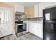 Well-equipped kitchen with stainless steel appliances and white cabinets at 6430 E Southport Rd, Indianapolis, IN 46237