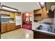 Cozy kitchen with wood cabinets and a view into the living room, showing the open floor plan at 6430 E Southport Rd, Indianapolis, IN 46237