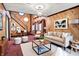 Cozy living room with wood-paneled walls, modern furniture, and natural light at 6430 E Southport Rd, Indianapolis, IN 46237