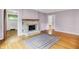Cozy living room featuring hardwood floors and a charming fireplace at 6430 E Southport Rd, Indianapolis, IN 46237