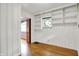 Sunlit room with built-in shelving and hardwood floors at 6430 E Southport Rd, Indianapolis, IN 46237