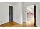 Clean and spacious room with hardwood floors and natural light at 6430 E Southport Rd, Indianapolis, IN 46237