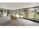 Spacious sunroom filled with natural light, featuring a large table and access to the outdoors at 6430 E Southport Rd, Indianapolis, IN 46237