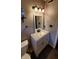 Well-lit bathroom with a modern vanity, mirror, and updated fixtures at 6637 Larkwood Ct, Indianapolis, IN 46241