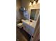 Cozy bathroom featuring a white vanity, commode, and decorative shelves at 6637 Larkwood Ct, Indianapolis, IN 46241