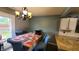 Cozy dining area with unique chandelier and view to outside at 6637 Larkwood Ct, Indianapolis, IN 46241