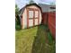 Outdoor shed in a fenced backyard with green grass at 6637 Larkwood Ct, Indianapolis, IN 46241