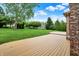A partial view of the backyard deck with manicured green lawn at 7310 Monaghan Ln, Indianapolis, IN 46217