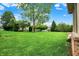 A spacious backyard featuring a lush green lawn with trees at 7310 Monaghan Ln, Indianapolis, IN 46217