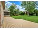 Home showcasing a large wooden deck with a view of the spacious backyard at 7310 Monaghan Ln, Indianapolis, IN 46217