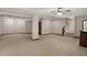 Unfinished basement with carpet, white walls, and wooden stairwell at 7310 Monaghan Ln, Indianapolis, IN 46217