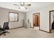 Spacious bedroom featuring neutral carpet, ceiling fan, window, and trim work details at 7310 Monaghan Ln, Indianapolis, IN 46217
