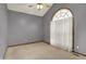 Relaxing bedroom with vaulted ceiling, ceiling fan, large arched window and neutral decor at 7310 Monaghan Ln, Indianapolis, IN 46217