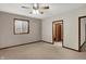 Bedroom with neutral carpet, ceiling fan, window and wood trim at 7310 Monaghan Ln, Indianapolis, IN 46217