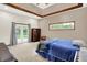 Bright bedroom features french doors, trey ceiling, and large window at 7310 Monaghan Ln, Indianapolis, IN 46217
