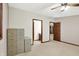 Carpeted bedroom featuring filing cabinets, with view of the bathroom and door to the hall at 7310 Monaghan Ln, Indianapolis, IN 46217