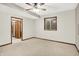 Cozy bedroom with neutral carpet, ceiling fan, natural light, and wood trim at 7310 Monaghan Ln, Indianapolis, IN 46217
