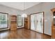A spacious dining room features hardwood floors, built-in bookshelves, and French doors with white curtains at 7310 Monaghan Ln, Indianapolis, IN 46217