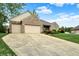 Brick home with a large driveway and two-car garage at 7310 Monaghan Ln, Indianapolis, IN 46217