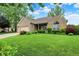 Beautiful single story brick house with a well maintained lawn and blue skies at 7310 Monaghan Ln, Indianapolis, IN 46217