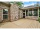 Brick home's exterior showcasing a deck and screened-in patio for outdoor living at 7310 Monaghan Ln, Indianapolis, IN 46217